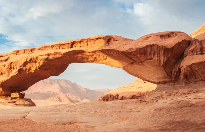 Natural sandstone rock arch in Wadi Rum, Jordan