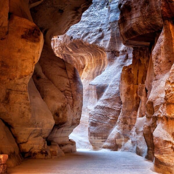 The narrow sandstone Siq passage leading into Petra, Jordan