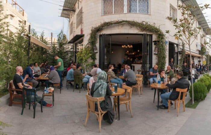 Local residents and visitors at an outdoor café in Amman, Jordan